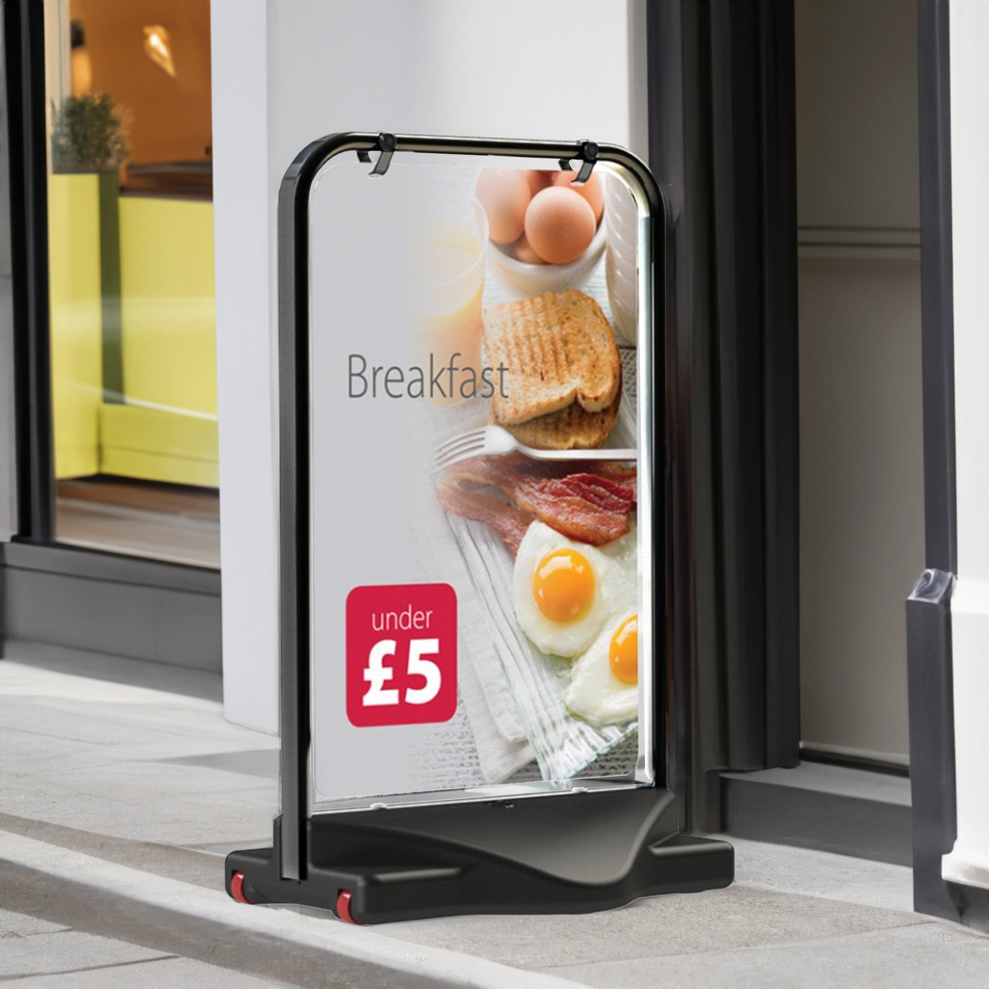 A sturdy A1 black swing pavement sign with a durable water-filled base, featuring a double-sided display for maximum visibility in outdoor advertising and promotions.
