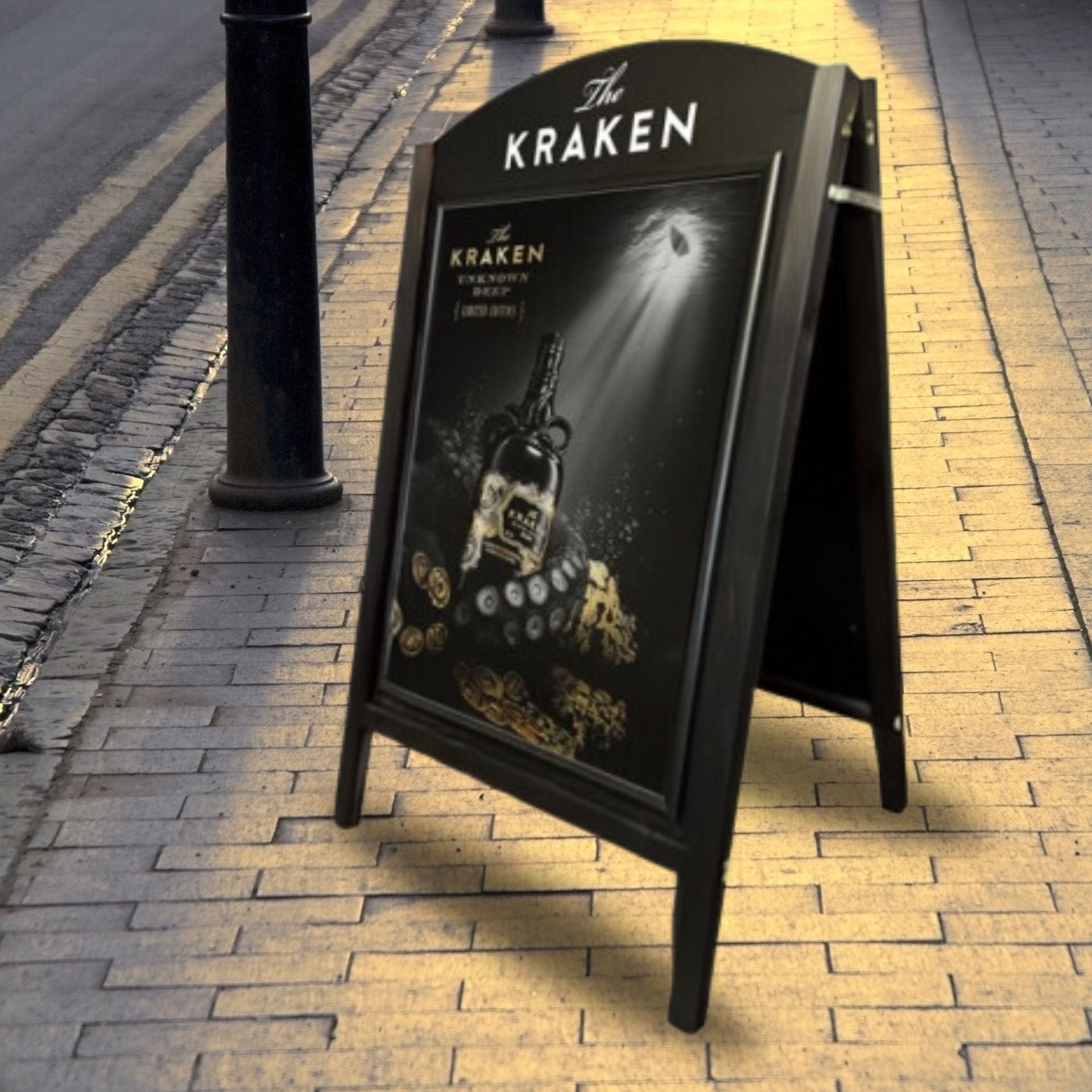 A stylish black curved wooden A1 A-board pavement sign, featuring a dual display with a chalkboard panel and a snap frame for versatile advertising.
