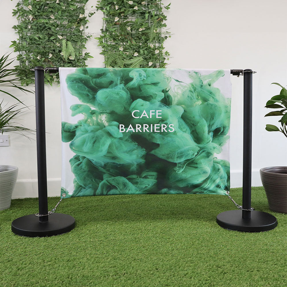 Heavy-duty black steel café barrier with a 1.5m printed double-sided banner, designed for cafés, restaurants, and retail spaces.
