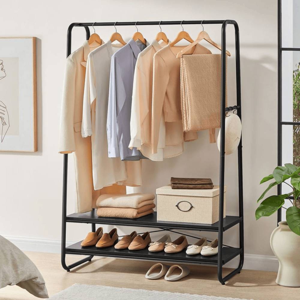 Black steel clothes rail with black wooden shelves and hooks, perfect for stylish and functional storage.
