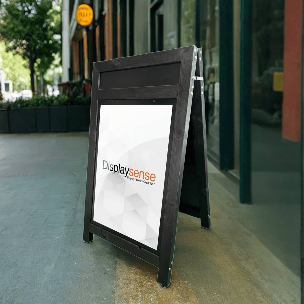 A sleek black wooden A1 A-board pavement sign with a built-in header, offering a professional and eye-catching display for promotions, menus, or special offers.

