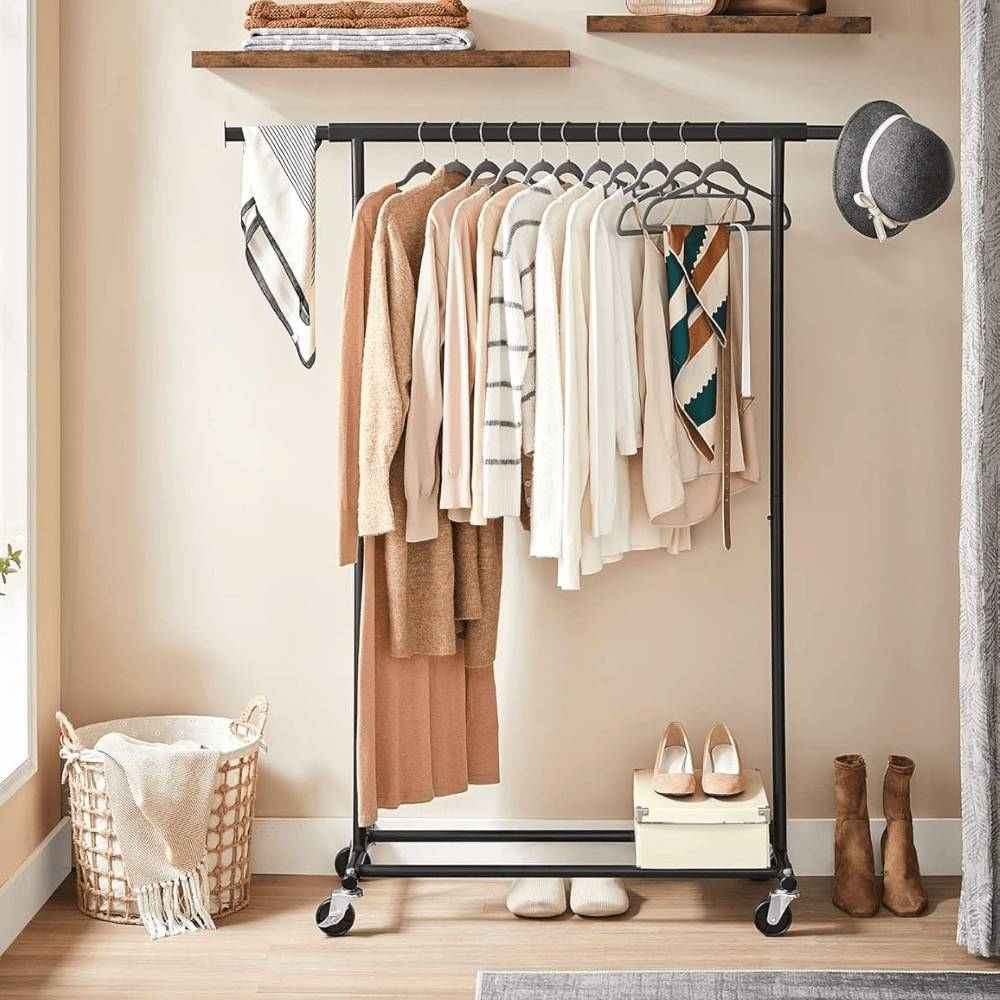 Extendable black steel clothes rail with integrated storage and a shoe shelf, perfect for organising garments and footwear.
