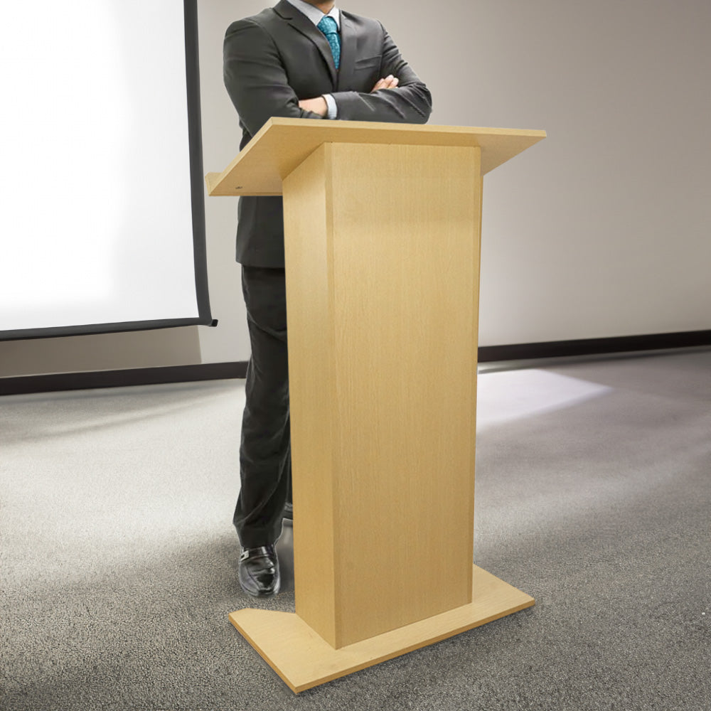 Light wood floor-standing lectern podium with built-in shelf, measuring 685mm wide by 1180mm high, ideal for presentations and speeches.