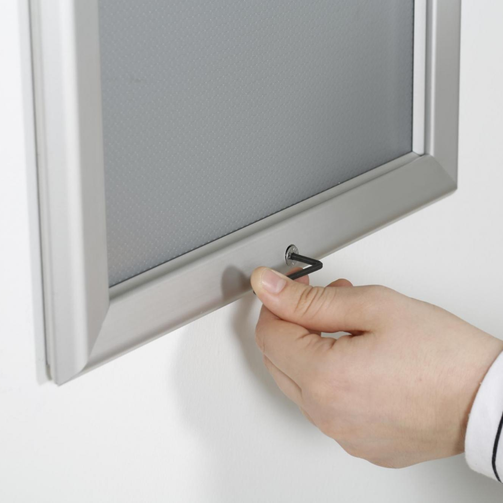 Lockable poster snap frame in silver aluminium with a mitred edge, supplied with wall fixings for easy installation.
