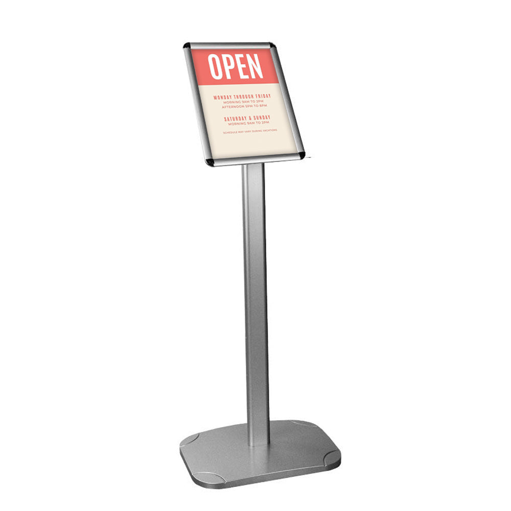 Floor-standing A4 poster display stand in silver with a 25mm mitred snap frame and adjustable orientation, 1050mm H x 330mm W.
